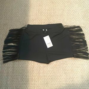 Black fringe shorts, black fringe crop top with middle knot, and sparkly belt